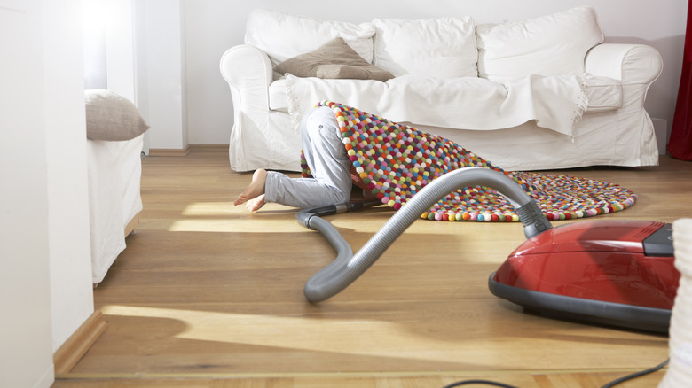 Vacuuming under a rug