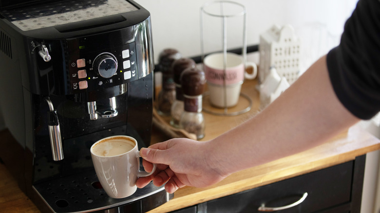 Man preparing cappuccino with home espresso machine