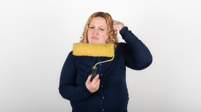 woman looking confusedly at roller