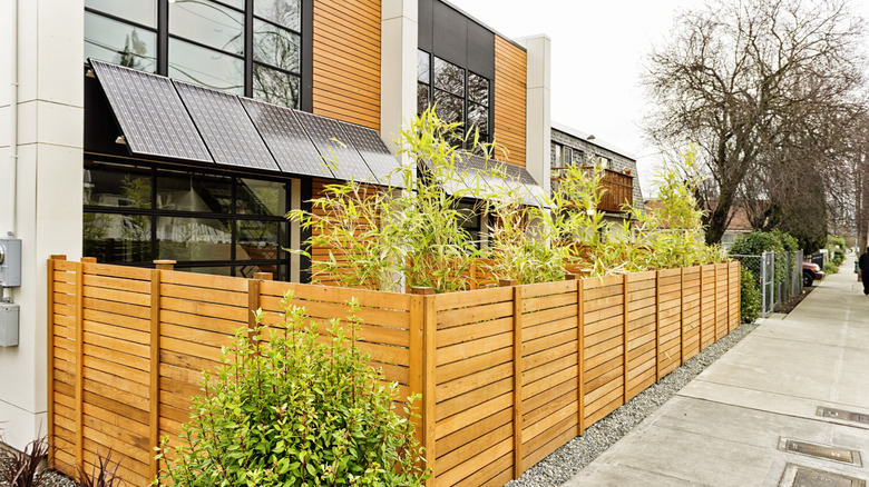 A modern horizontal fence around a small yard