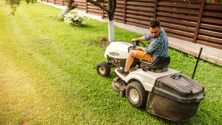 Man mowing lawn with riding mower