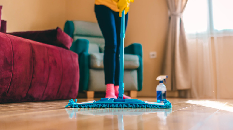 close up of young woman mopping hardwood floor