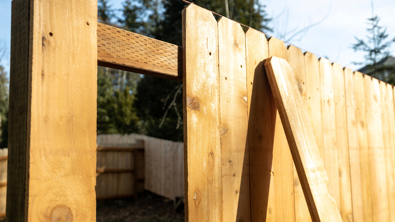 wood fence in the process of being built