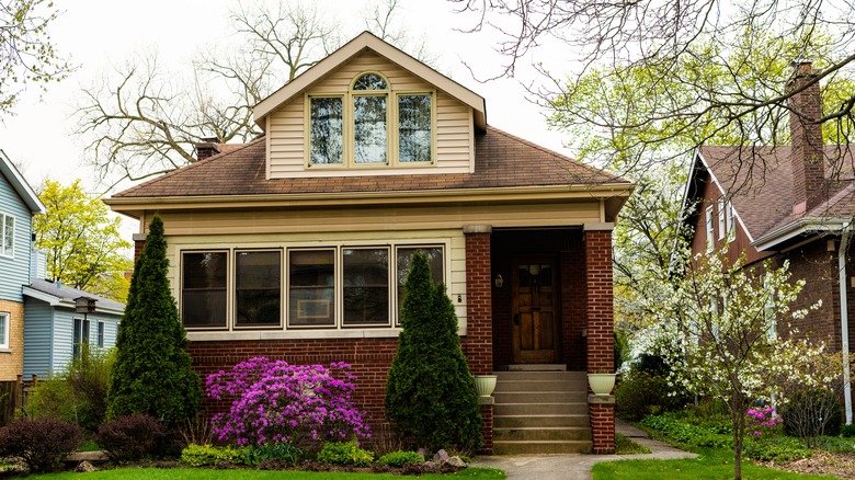 A small brick home on a residential street.