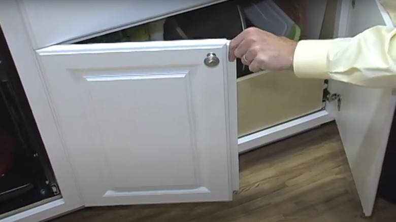 screenshot of center cabinet stile removed and attached to the back of one of the cabinet doors to cover the gap in white lower cabinets