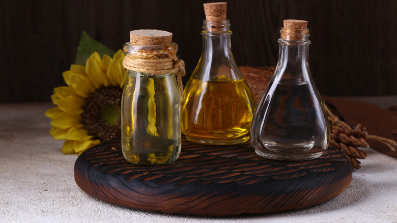 Natural oils on a wooden board sunflower in the background