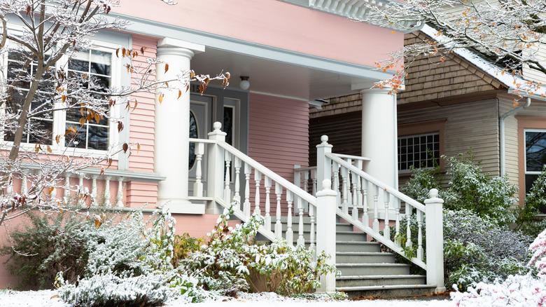 a pink house with wood siding