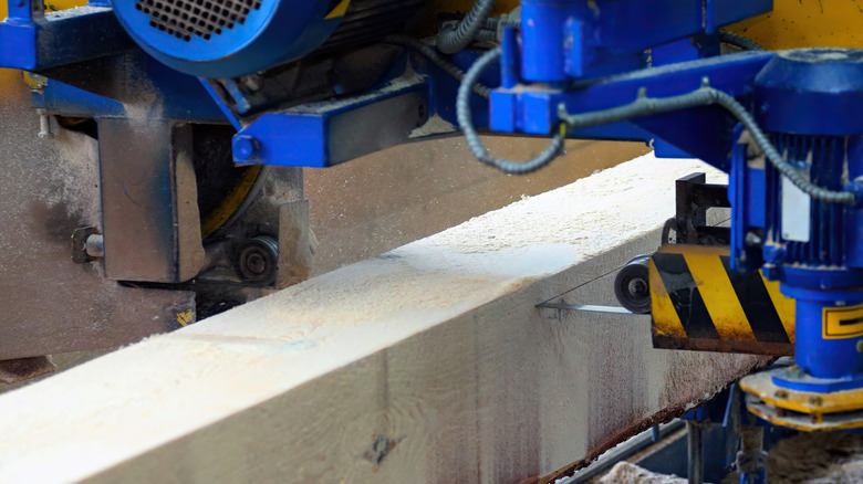 a blue and yellow tool milling lumber